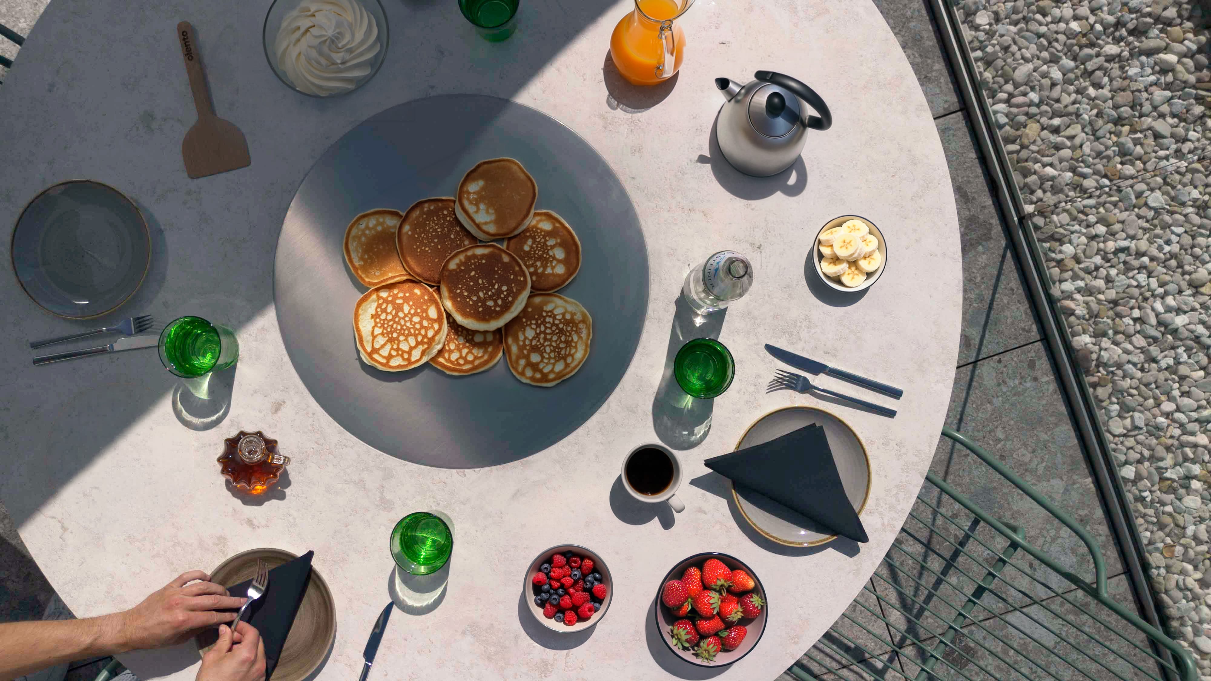 Pancakes on the teppanyaki plate, breakfast table from above